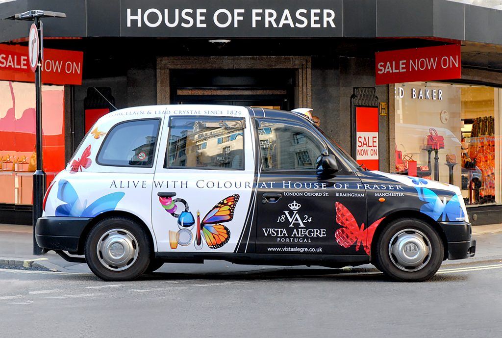 Taxi driving by house of fraser